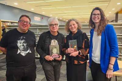 Two authors and their interviewers posed smiling for a photo.